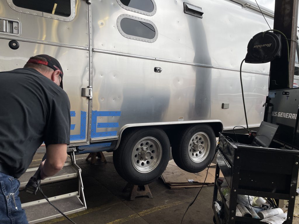 A person working on a trailer

Description automatically generated