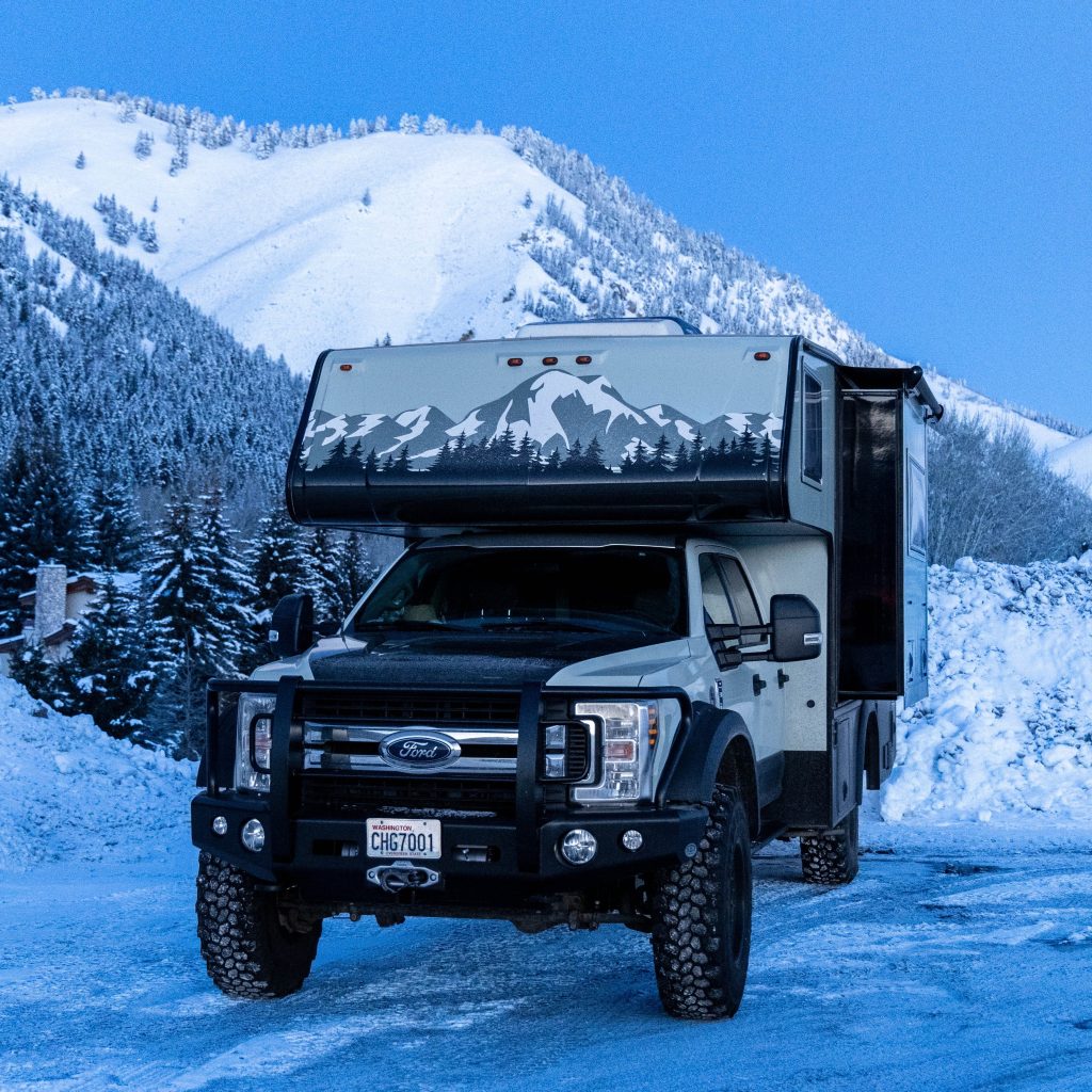A truck parked in the snow
Description automatically generated
