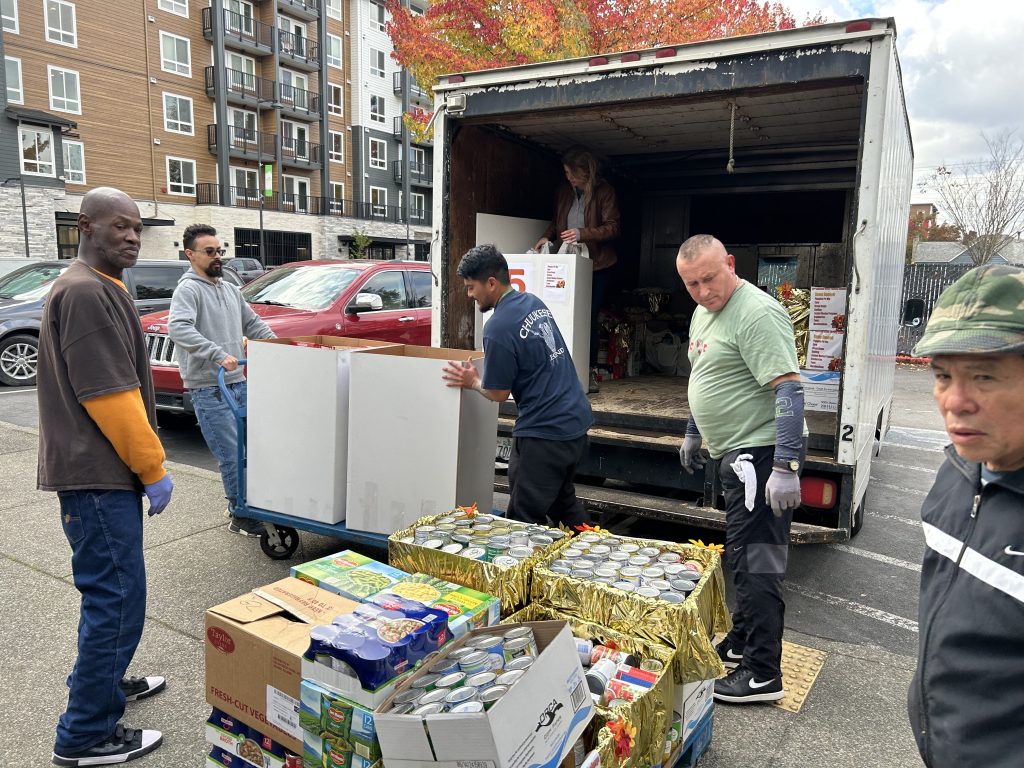A group of men loading boxes into a truck
Description automatically generated